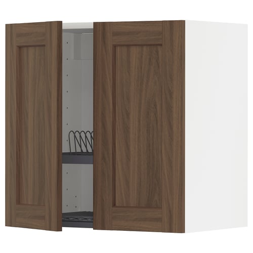 A METOD kitchen cabinet. It has walnut-colored doors and a white interior. One door is open, revealing shelves and a black wire dish drainer.