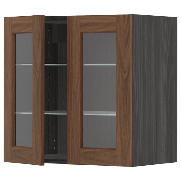 A wooden cabinet named METOD with glass doors in walnut finish, featuring adjustable shelves.