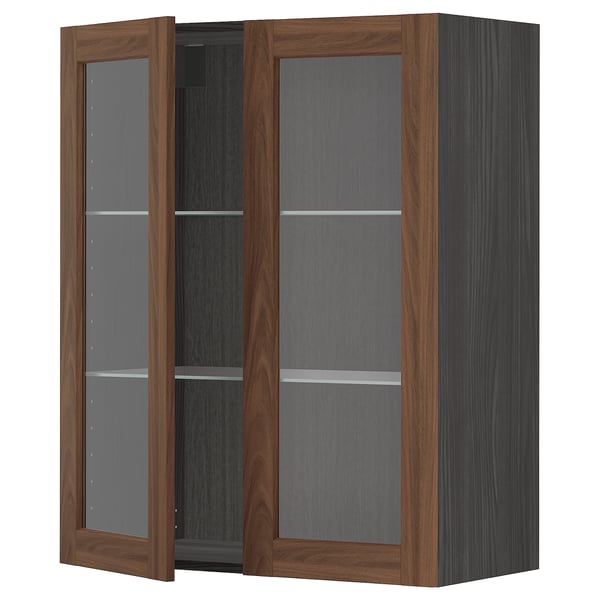 METOD kitchen cabinet with walnut-brown doors and glass panels.
