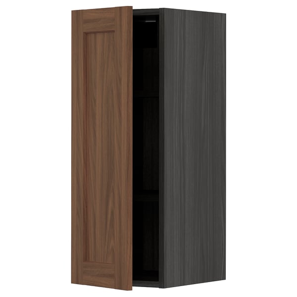 An open METOD kitchen cabinet with a dark wooden finish. It a minimalist design with a single door.