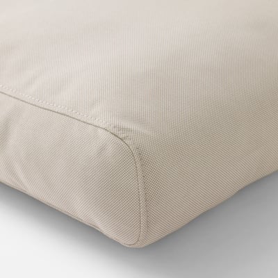 Close-up of beige outdoor cushion, fine texture, quality fabric.