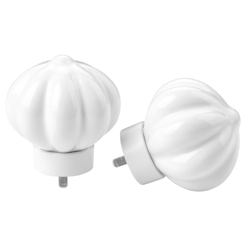 Two white decorative finials, shaped like flower buds, made of ceramic, with metallic screws, for curtain rods.