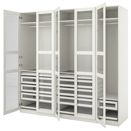 An open white ikea PAX wardrobe with multiple drawers and shelves for storage.
