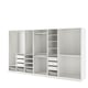 White PAX wardrobe system with shelves, drawers, hangers, and adjustable feet.