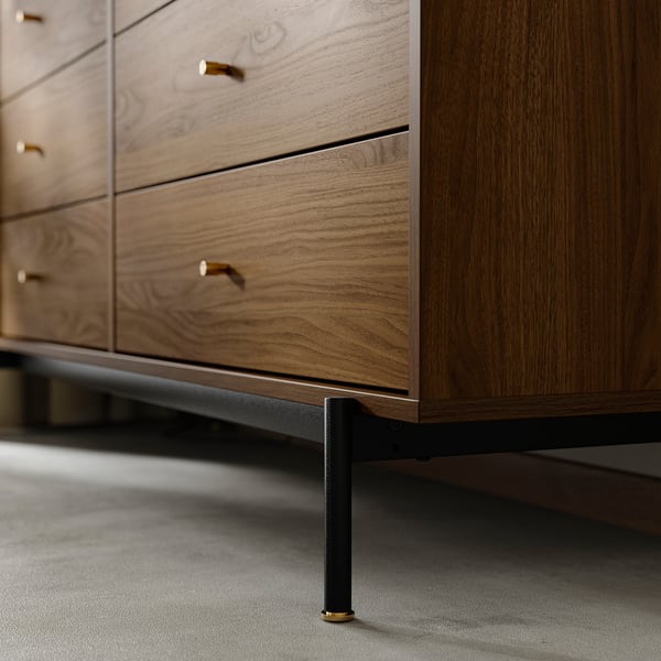 Wooden dresser detail, warm walnut, gold handles, black legs.