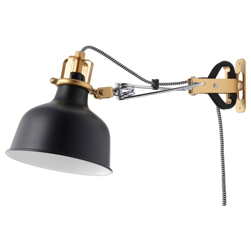 A RANARP lamp, black with gold accents, adjustable, and wall-mountable, featuring a classic textile cord.