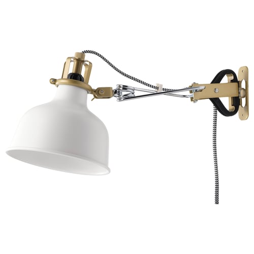 The RANARP wall lamp in white with gold accents, a striped cord, and adjustable arms.