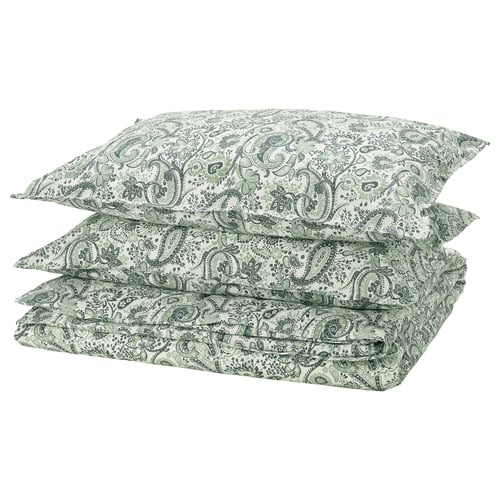 Three green paisley-patterned pillows with white backgrounds are neatly stacked.