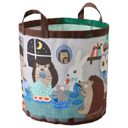 Enchanted forest-themed SKOGSDUVA storage basket, round, with hedgehog family at tea party. Brown handles, green sides, made from recycled polyester.