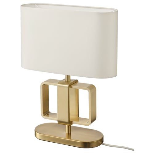 An UPPVIND table lamp. It is gold-colored with an oval white shade. The base has a modern, geometric design made of metal.