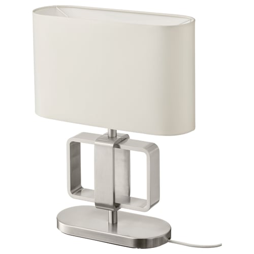 The UPPVIND lamp a sleek, oval white shade on a sturdy, polished metal base with rectangular cutouts. Elegant and modern design.