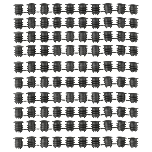 Image multiple rows of black VARIERA cabinet hole covers, displaying their cylindrical shape and ribbed design made of polyethylene plastic.