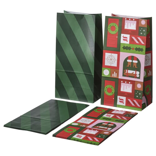 Two sets of green paper gift bags with diagonal stripes and colourful christmas designs. One set is upright, the other flat on a white surface.