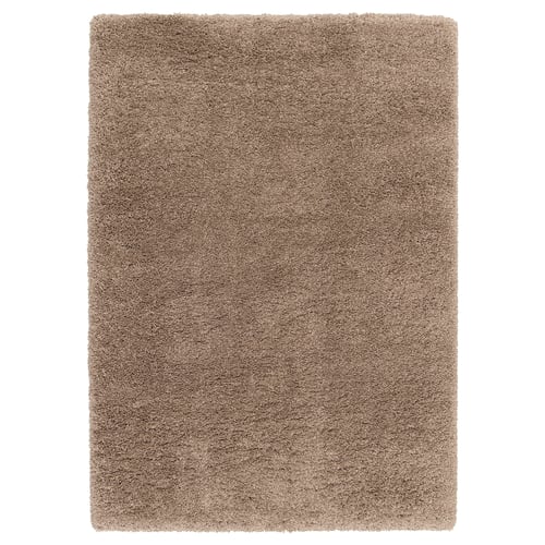 A VOLLERSLEV shaggy beige area rug with varying yarn thicknesses, offering a soft texture and sound-dampening properties.