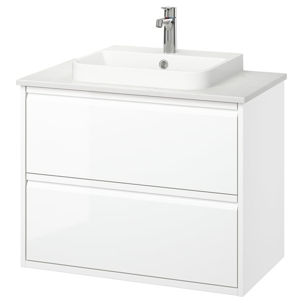 Tocador de bany blanc de paret, disseny modern i elegant amb dos calaixos, tiradors integrats i un lavabo de marbre semi-encastat.