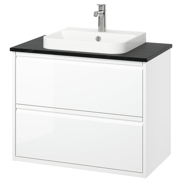 Moble de bany blanc modern amb taulell negre i lavabo quadrat. De paret amb dos calaixos. Acabat d'alta brillantor i disseny minimalista.