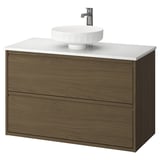 Modern moble de bany de paret de fusta fosca amb taulell blanc i lavabo rodó. Disseny minimalista.