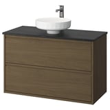 Tocador de bany ÄNGSJÖN: fusta de noguera, taulell de marbre fosc, lavabo circular blanc, dos calaixos.