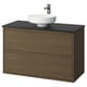 Tocador de bany ÄNGSJÖN: fusta de noguera, taulell de marbre fosc, lavabo circular blanc, dos calaixos.