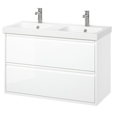 És un tocador de bany blanc de doble lavabo de paret amb disseny modern, dos calaixos i aixetes cromades.