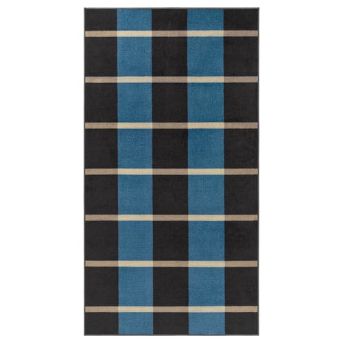 La catifa ARBETSZON en color blau i gris fosc amb ratlles beix, forma rectangular i disseny a quadres.