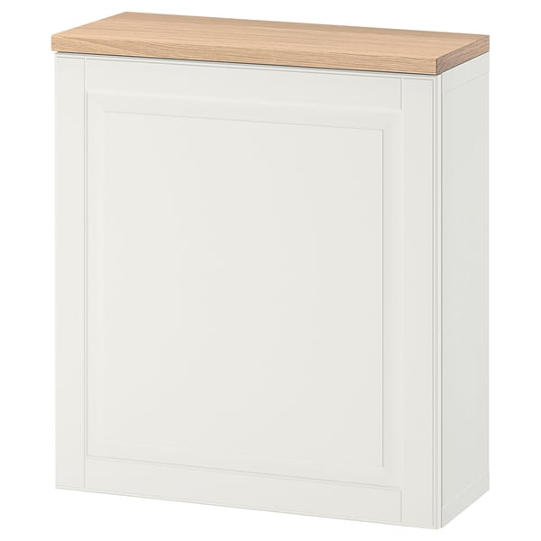 Un armari d'emmagatzematge BESTÅ de color blanc trencat amb tapa de fusta. Té un disseny elegant i modern amb prestatges ajustables.