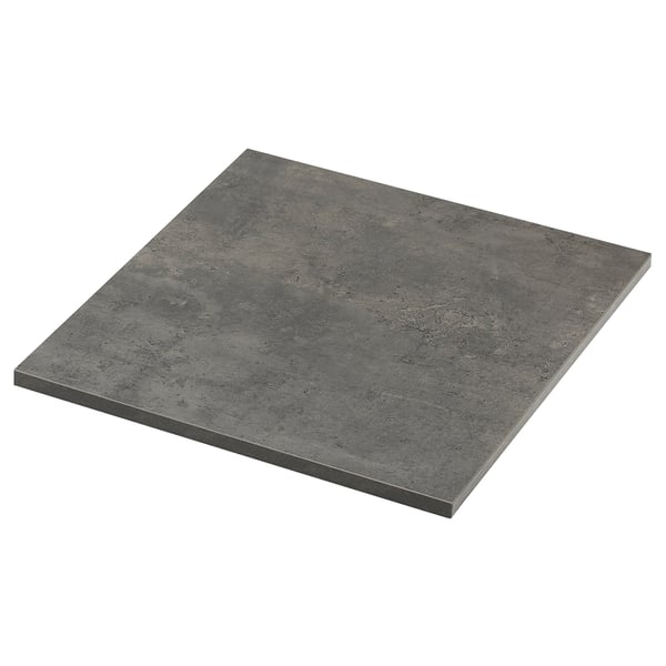 Un taulell EKBACKEN de color fosc, de forma rectangular, amb un disseny suau i modern, fabricat en laminat i taulers de partícules.