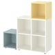 Prestatgeria EKET: emmagatzematge cub blanc amb prestatge lateral blau clar, disseny modular, quatre compartiments quadrats.