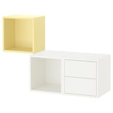 Dos cubs d'emmagatzematge moderns, un groc i un blanc; cubs minimalistes i quadrats amb obertura i un amb calaixos.