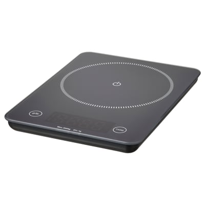 Una bàscula de cuina digital GENOMSNITT, negra, amb tapa de vidre quadrada i pantalla digital.