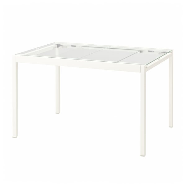 Una taula de vidre GLIVARP blanc. El seu disseny modern, quatre potes metàl·liques blanques i una taula de vidre temperat transparent.
