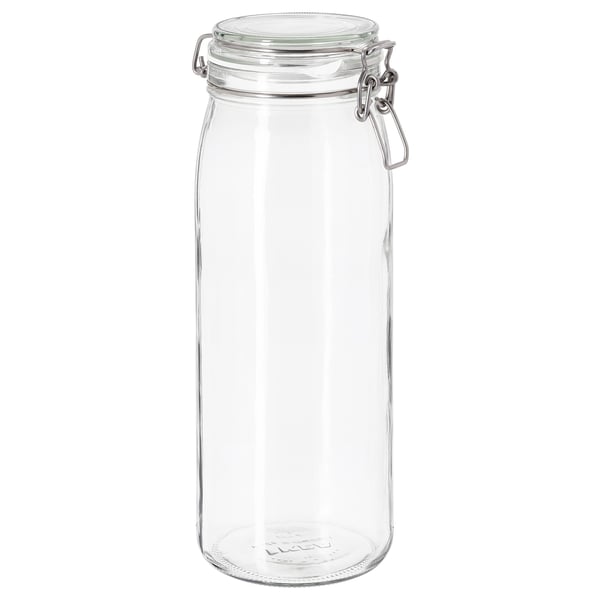Un pot de vidre transparent anomenat KORKEN amb tancament platejat i segell de goma, dissenyat per emmagatzemar aliments o begudes.