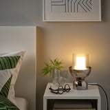 Dormitori modern amb llum MOLNART, planta i art abstracte.
