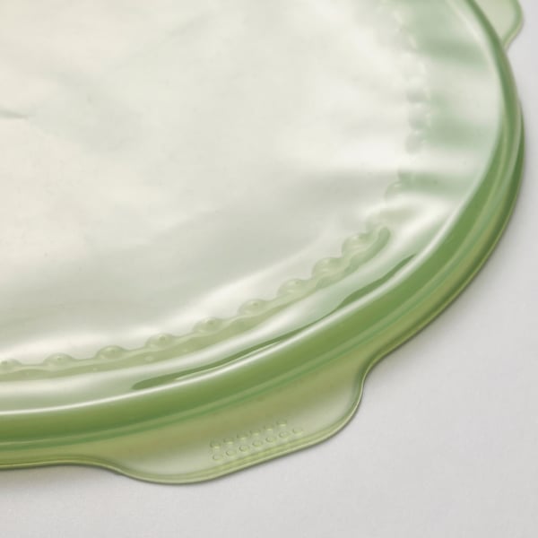 Coberta d'aliments de cautxú de silicona verda, part superior llisa, vora texturitzada, es manté plana.