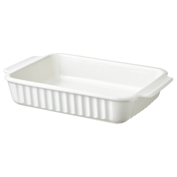Un plat de forn oblong blanc amb nanses, de gres, dissenyat per a diversos forns.