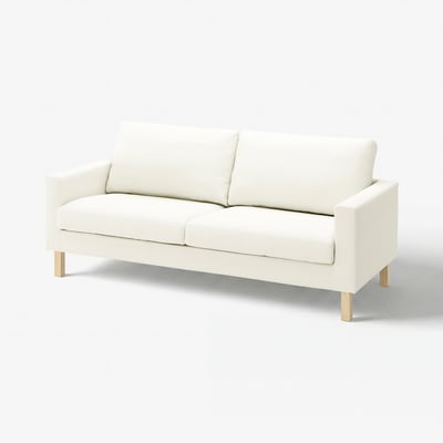 El sofà SALTSJÖBADEN, un sofà blanc amb un disseny prim i modern. Té potes de fusta i està entapissat amb teixit de cotó.