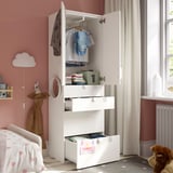 Armari infantil amb portes obertes que mostren roba i emmagatzematge. Inclou ganxos i calaixos per a un emmagatzematge organitzat.