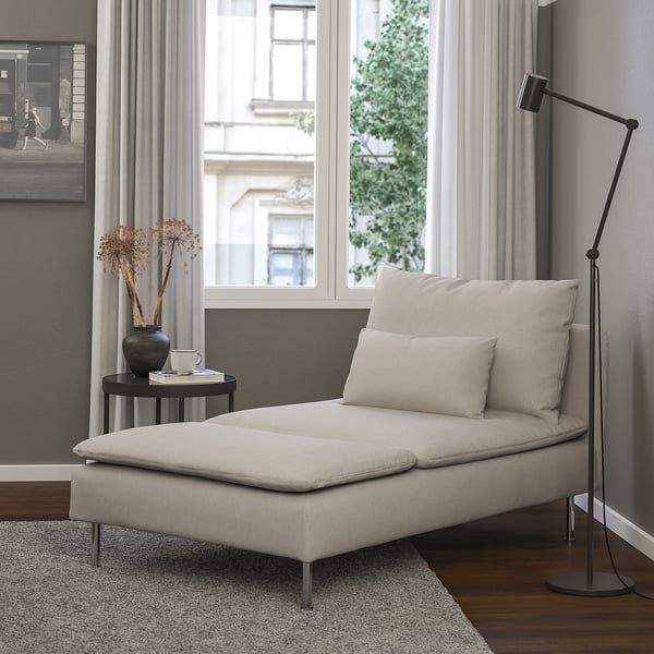 Habitació moderna amb chaise SÖDERHAMN al costat de la finestra, llum de peu, taula auxiliar i finestra drapejada.