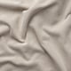 Funda de sofà beix amb textura de primer pla, teixida amb diferents tons, que mostra la durabilitat i el patró elegant.