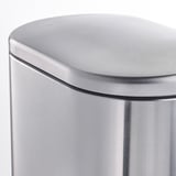 Primer pla d'un elegant contenidor d'escombraries d'acer inoxidable corbat, vora llisa de la tapa, que mostra el seu disseny modern i resistent.