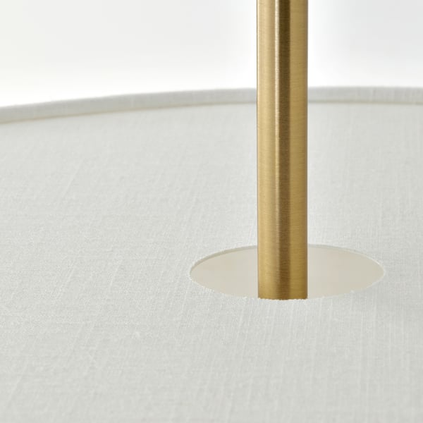 Base de llum de color daurat fermament col·locada en retall circular de superfície de textura blanca.