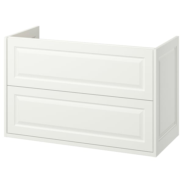 Un tocador de bany TÄNNFORSEN blanc amb detalls clàssics i vores bisellades. Té dos calaixos i està dissenyat per al muntatge a la paret.