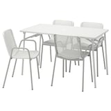 Conjunt de pati blanc modern amb estructura metàl·lica grisa, taula quadrada i quatre cadires.