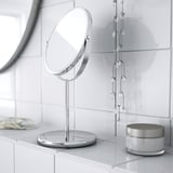 Un mirall de tocador elegant i de sobretaula amb base, amb un costat d'augment i un costat reflectant regular, ideal per maquillar-se o afaitar-se.