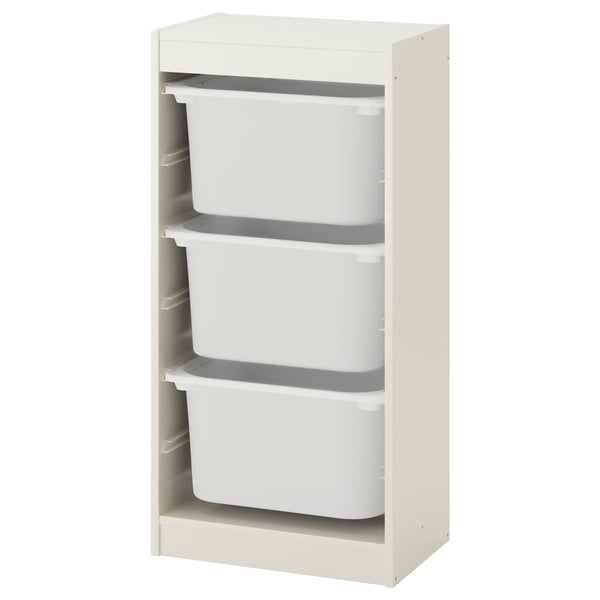 Un traster TROFAST blanc trencat amb tres contenidors de plàstic blanc. Té un disseny modern i minimalista amb un marc de fusta.