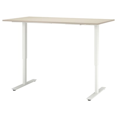 Taula ajustable Trotton de color beix clar amb potes blanques.