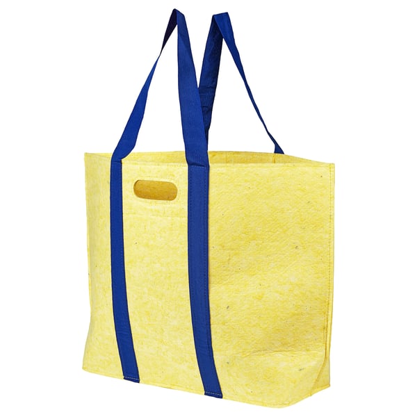 Una bossa de la compra groga de vaxelbruk amb corretges blaves, feta amb materials reciclats.