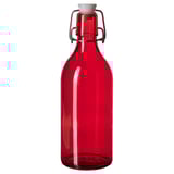 Ampolla de vidre vermell amb tap flip-top, ideal per a sucs i batuts.