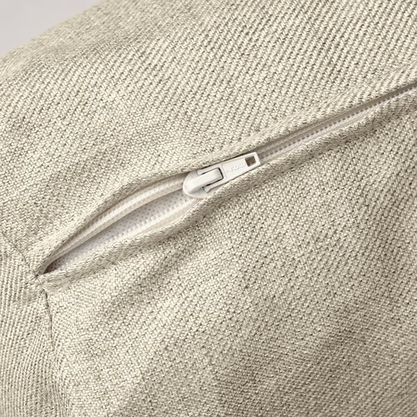 Sofà llit beix amb primer pla de cremallera blanca llisa que mostra costures de qualitat i textura de teixit.