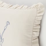 Decorative cushion cover with hand-embroidered flowers, cream with ruffled edges, high-quality cotton.